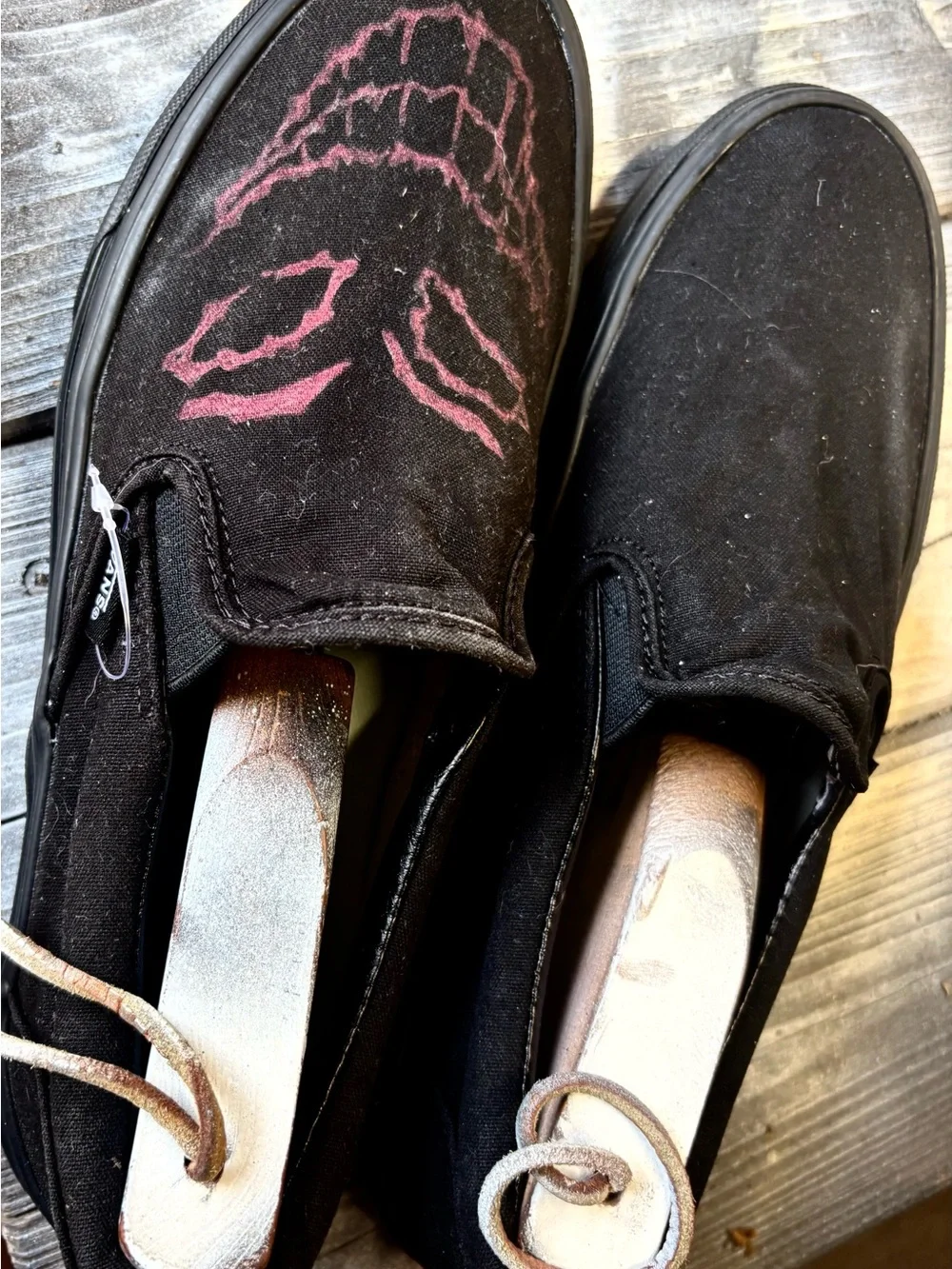 Vans black slip-on canvas sneakers with red hand-painted smiley face